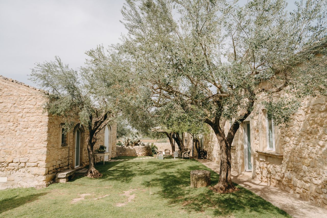 The courtyard at Baglio Occhipinti - olive trees between old stone buildings